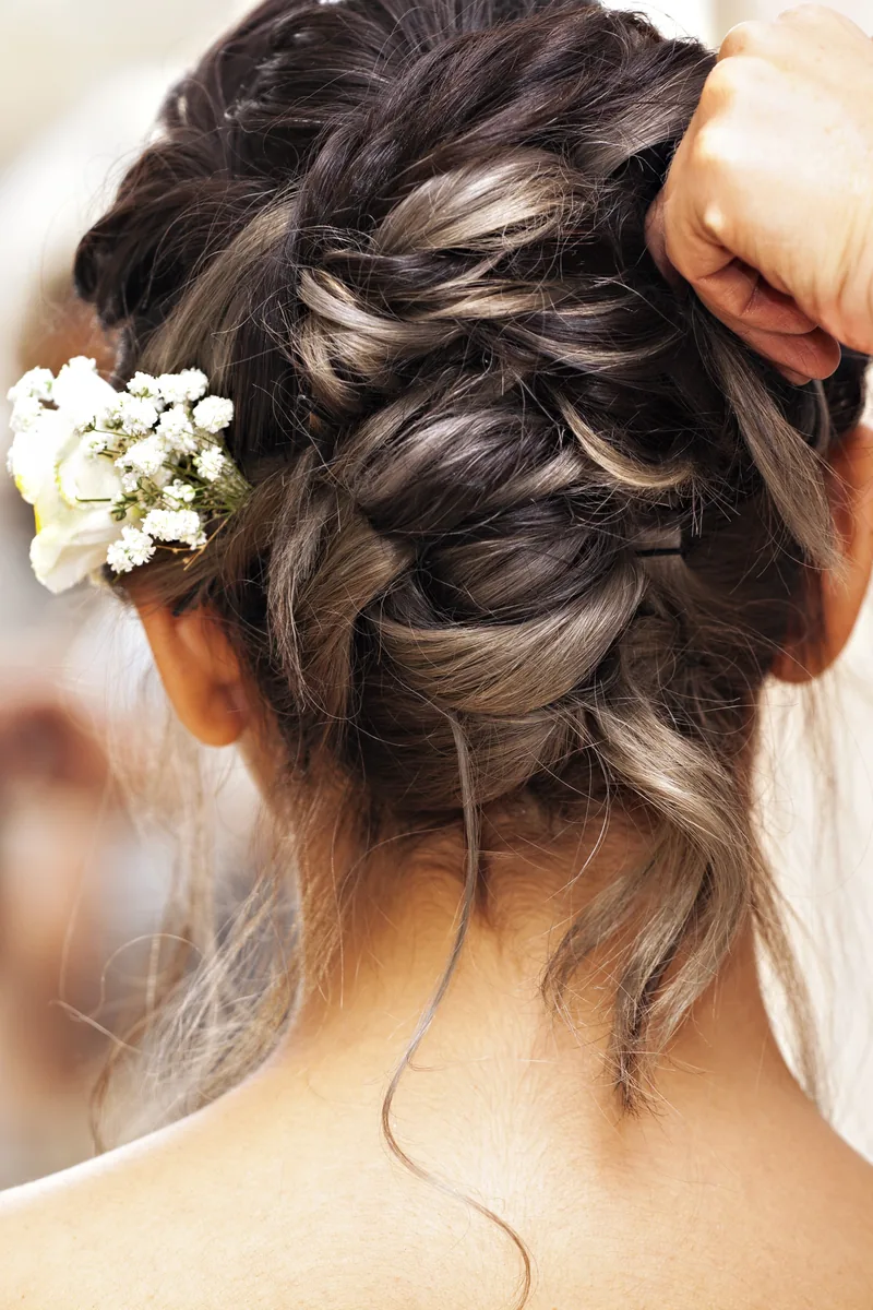 Braided bridal updo with baby's breath and veil being fitted, LaBara Salon Buckhead Atlanta